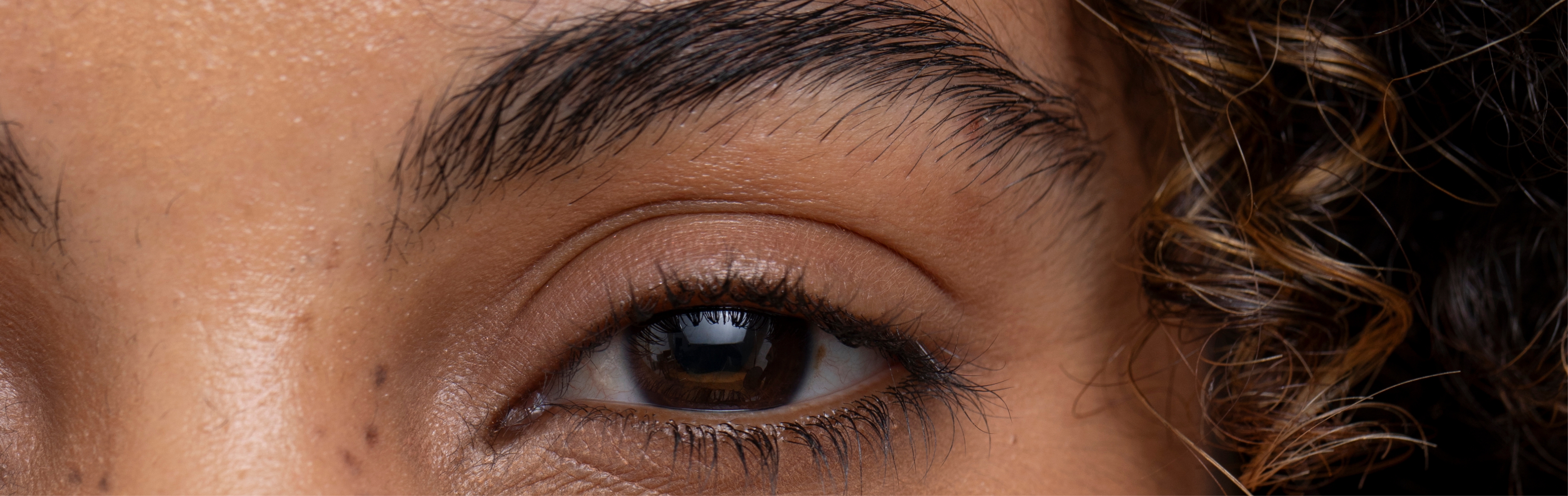 Southern Face and Body lady facing the camera close up of her eye with smooth skin
